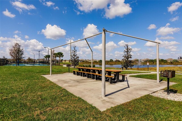 view of community featuring a water view and a lawn