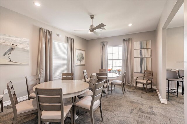 carpeted dining room featuring ceiling fan