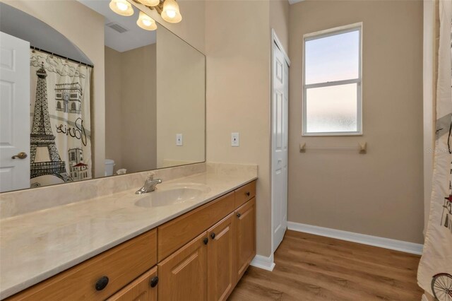 2262 Rio De Janeiro Ave, Punta Gorda, FL 33983 - bathroom featuring baseboards, wood finished floors, vanity, and toilet