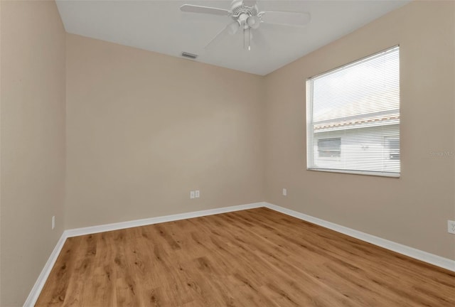 spare room with ceiling fan and light wood-type flooring