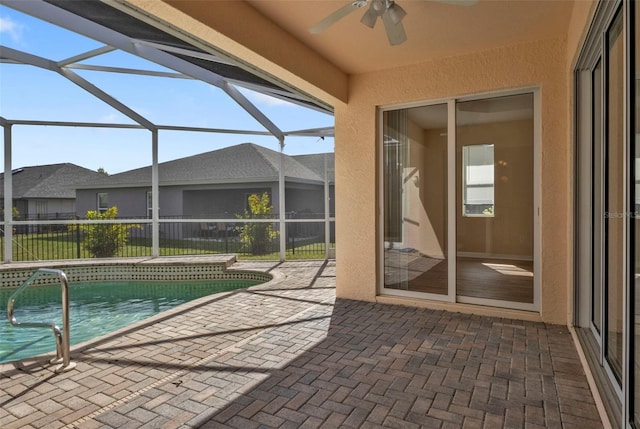 view of pool with a lanai, ceiling fan, and a patio area