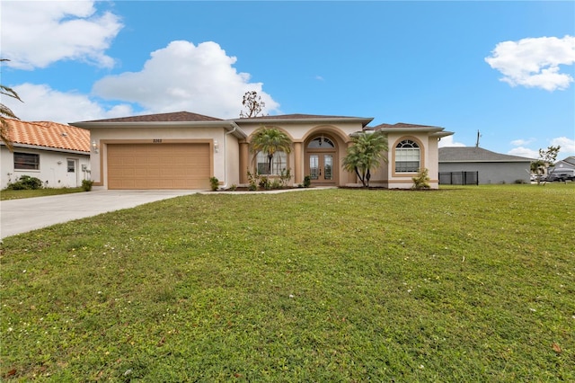 mediterranean / spanish-style home featuring french doors, a front lawn, and a garage