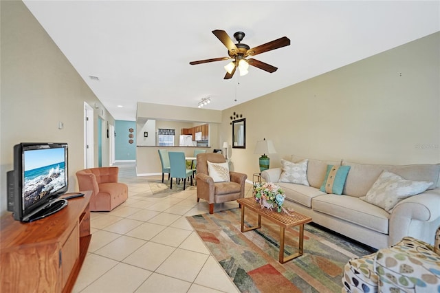 living room featuring ceiling fan and light tile patterned floors