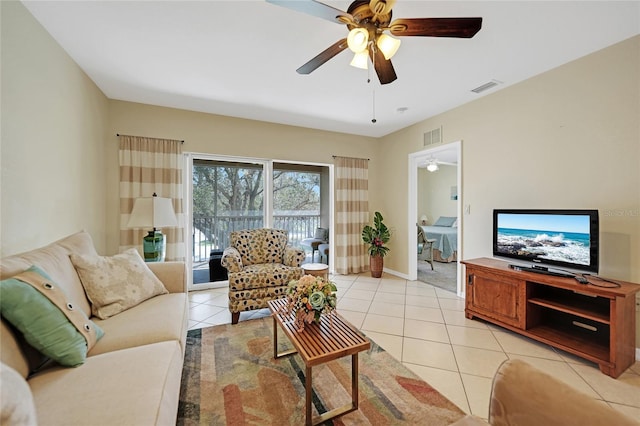 living room with light tile patterned flooring and ceiling fan