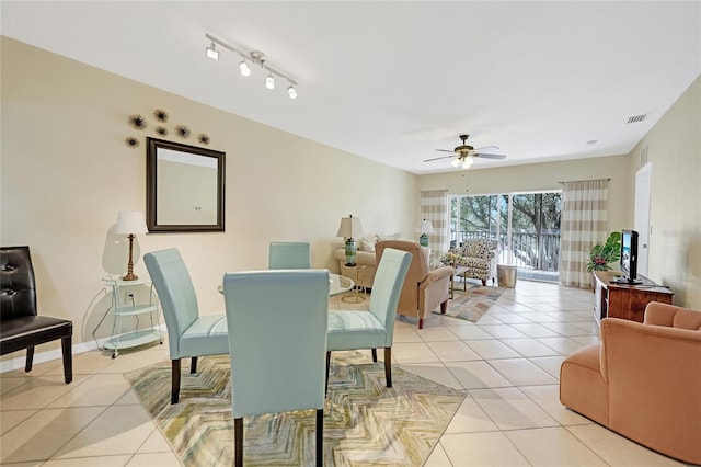 dining area with rail lighting, ceiling fan, and light tile patterned floors