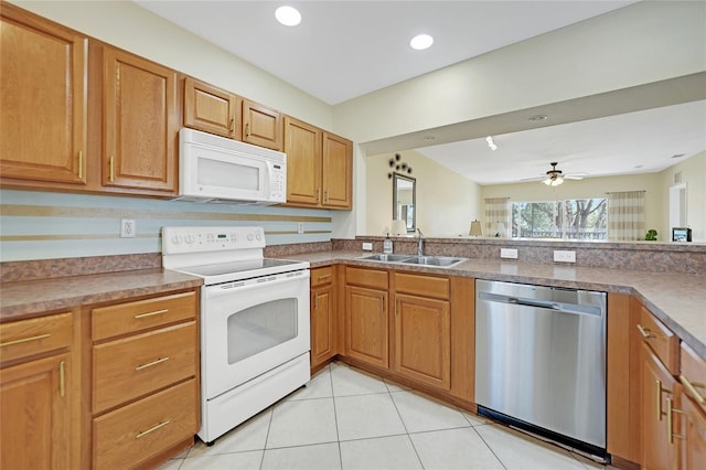 kitchen featuring light tile patterned flooring, ceiling fan, sink, and white appliances