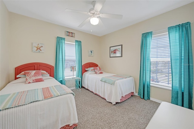 carpeted bedroom featuring ceiling fan and multiple windows