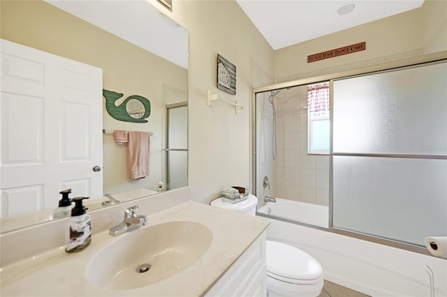 full bathroom with vanity, toilet, and combined bath / shower with glass door