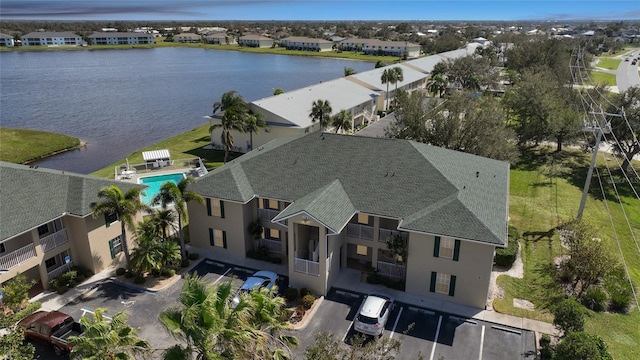 birds eye view of property with a water view