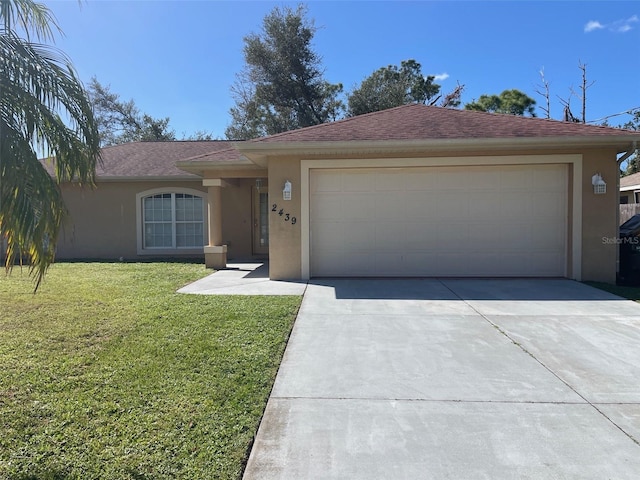 single story home with a front lawn and a garage