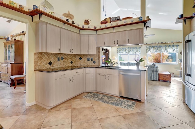 kitchen featuring high vaulted ceiling, stainless steel appliances, sink, and light tile patterned floors