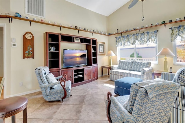 living room with ceiling fan, high vaulted ceiling, and light tile patterned flooring