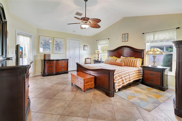 tiled bedroom with a closet, ceiling fan, and vaulted ceiling