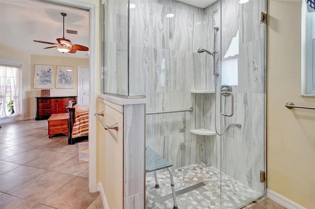 bathroom with tile patterned floors, ceiling fan, and walk in shower