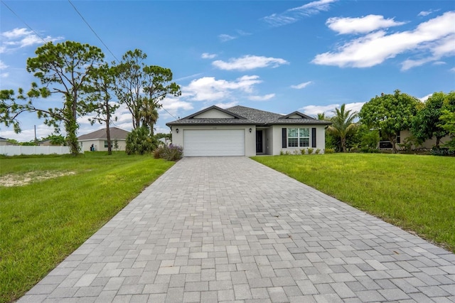 single story home featuring a garage and a front lawn