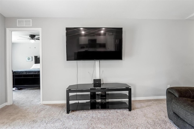 interior space featuring light carpet and ceiling fan