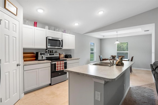 kitchen with white cabinets, a center island with sink, sink, pendant lighting, and stainless steel appliances