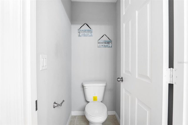 bathroom featuring toilet and tile patterned flooring