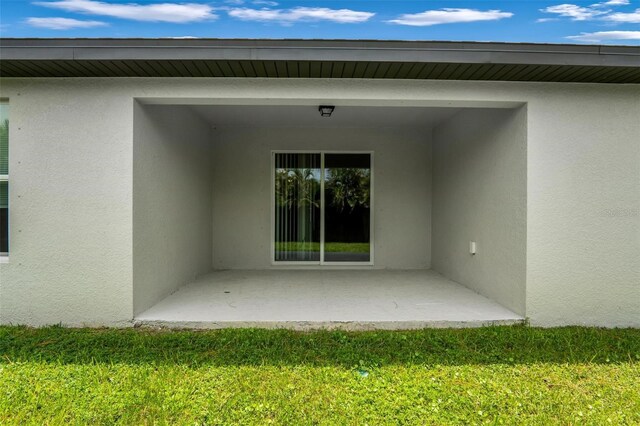 exterior space featuring a patio area and a lawn