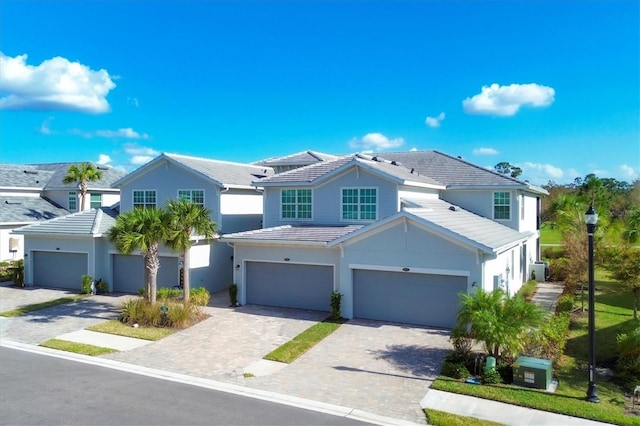 14640 Sycamore Ct Unit 2822, Punta Gorda, FL 33955 - view of front of home with a tiled roof, a garage, decorative driveway, and stucco siding