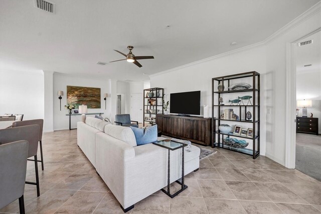 living room featuring ceiling fan and crown molding