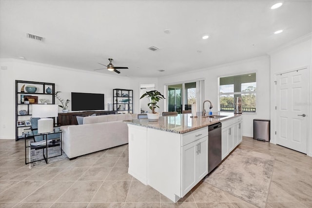 kitchen featuring a center island with sink, ornamental molding, light stone countertops, stainless steel dishwasher, and white cabinets