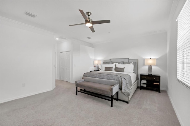 bedroom featuring ceiling fan, a closet, crown molding, and light colored carpet