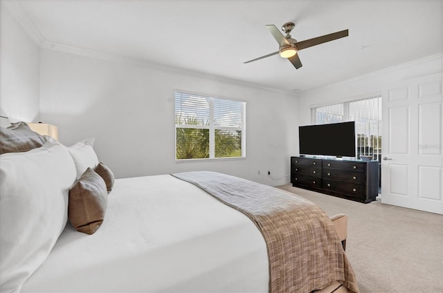 carpeted bedroom featuring ornamental molding and ceiling fan