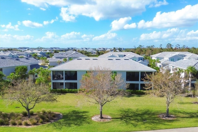 14640 Sycamore Ct Unit 2822, Punta Gorda, FL 33955 - rear view of house featuring a residential view, a sunroom, a lawn, and a tiled roof