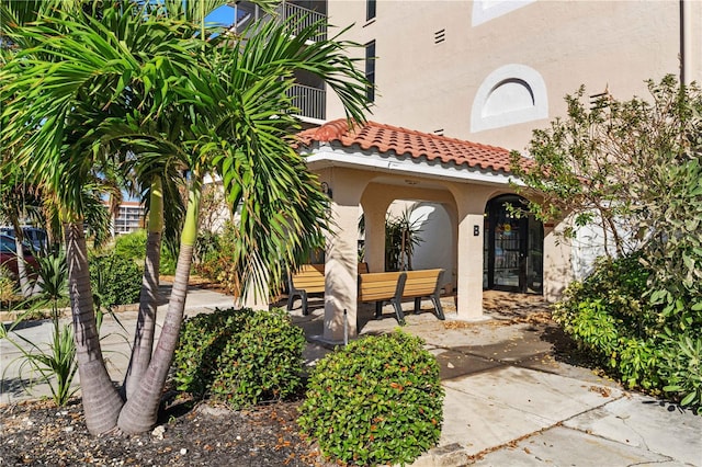 25188 Marion Ave Unit B304, Punta Gorda, FL 33950 - property entrance with stucco siding and a tile roof