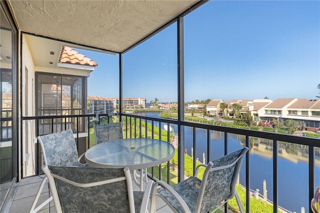 sunroom / solarium with a water view