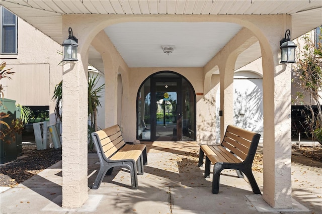 25188 Marion Ave Unit B304, Punta Gorda, FL 33950 - view of exterior entry with stucco siding and a patio