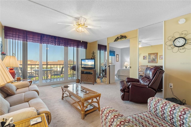 living room featuring carpet floors, a textured ceiling, and ceiling fan