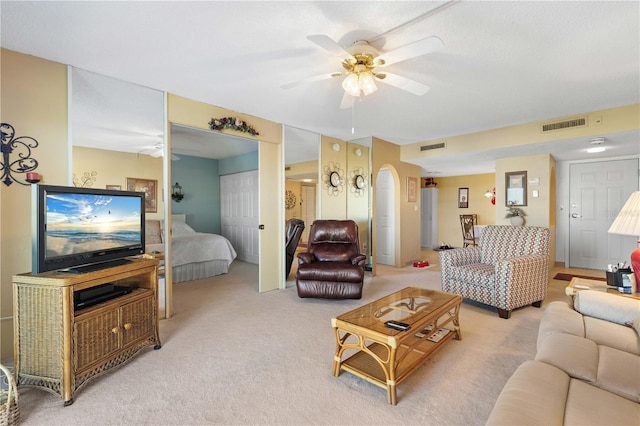 living room with light carpet and ceiling fan