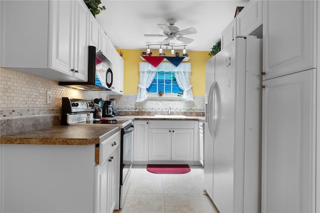 kitchen with light tile patterned floors, white fridge with ice dispenser, electric range, and white cabinets