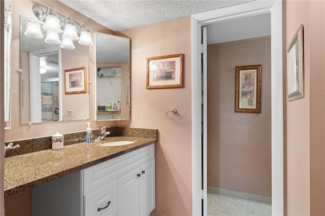 bathroom featuring vanity, a textured ceiling, and tile patterned flooring