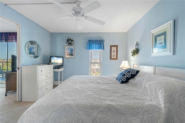 bedroom featuring a textured ceiling, multiple windows, and light colored carpet