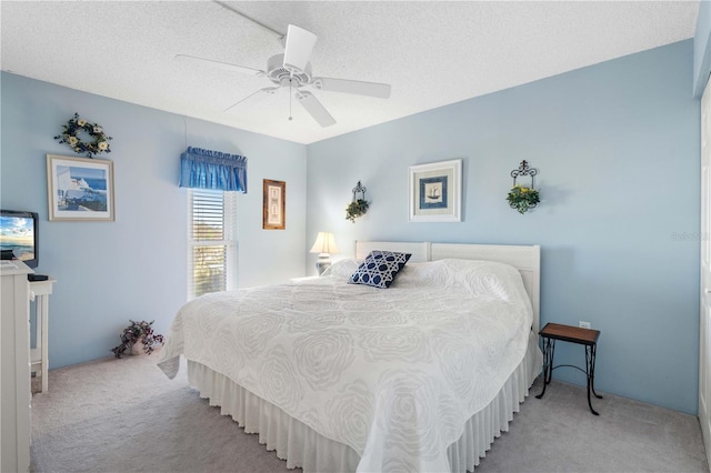 carpeted bedroom with a textured ceiling and ceiling fan