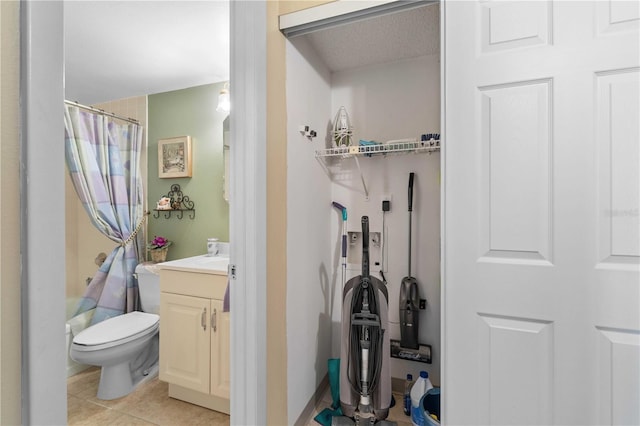 full bathroom with vanity, shower / tub combo, toilet, and tile patterned floors