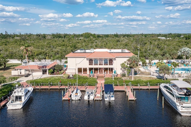 exterior space featuring a balcony and a water view