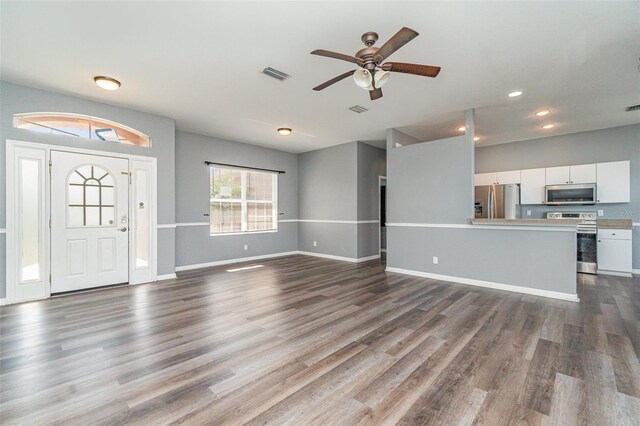 unfurnished living room featuring ceiling fan, dark wood-style flooring, visible vents, and recessed lighting