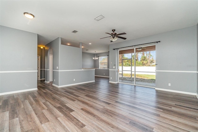 unfurnished living room with wood-type flooring and ceiling fan with notable chandelier