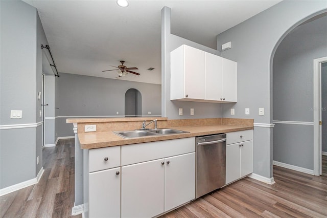 kitchen featuring sink, ceiling fan, stainless steel dishwasher, white cabinets, and light hardwood / wood-style flooring