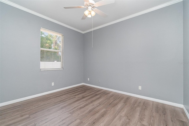 spare room featuring crown molding, light wood-type flooring, and ceiling fan