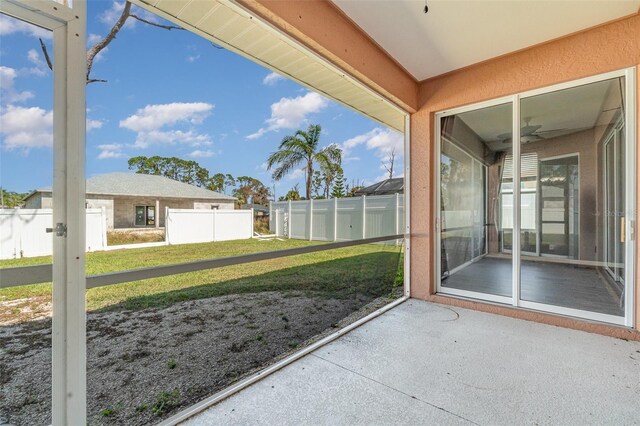 unfurnished sunroom with a ceiling fan