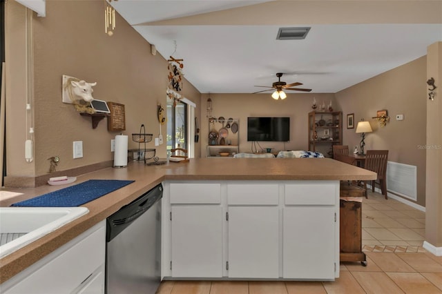 kitchen with kitchen peninsula, light tile patterned flooring, stainless steel dishwasher, white cabinetry, and ceiling fan