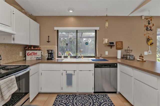 kitchen featuring white cabinetry, appliances with stainless steel finishes, sink, and plenty of natural light