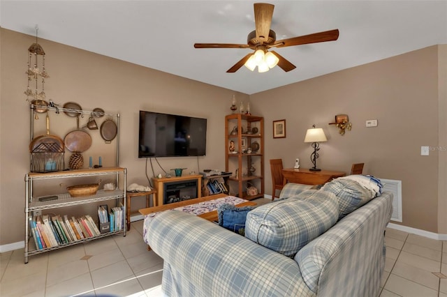 tiled living room with ceiling fan