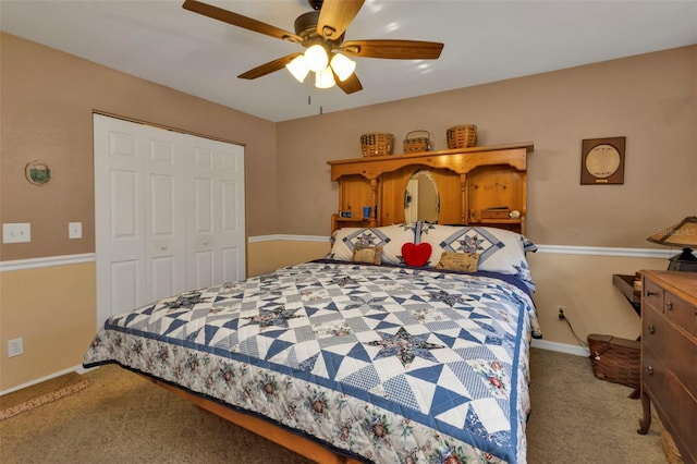 carpeted bedroom featuring a closet and ceiling fan