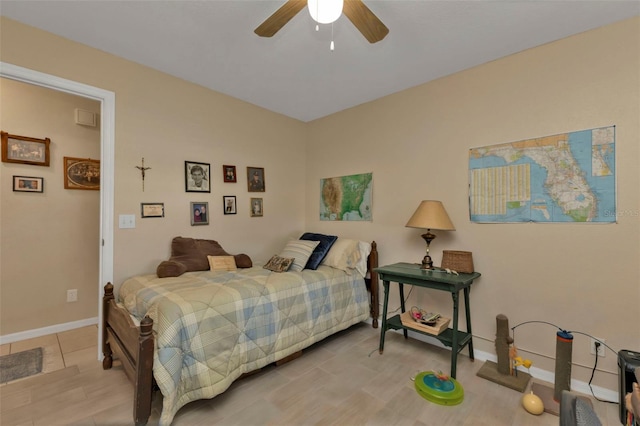 bedroom with light hardwood / wood-style floors and ceiling fan